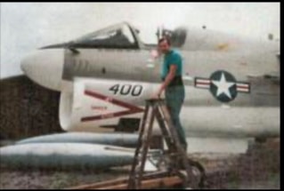 Worker painting the A7 Corsair aircraft fuselage