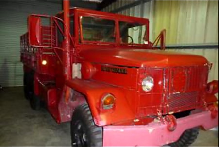 Red 1958 Deuce-and-a-Half Vietnam Era Gun Truck in garage