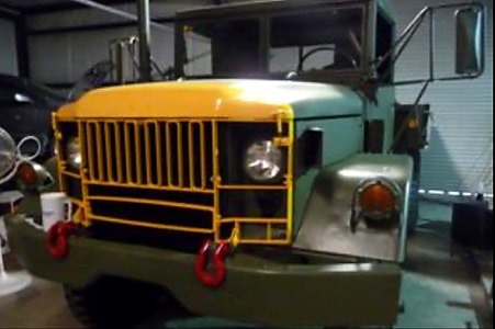 Front view of the Deuce-and-a-Half showing yellow grille guard in workshop
