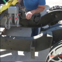 Worker positioning engine components in halftrack chassis