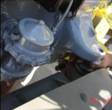 Close-up of engine bell housing being seated in halftrack chassis