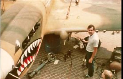 Pilot standing beside military aircraft